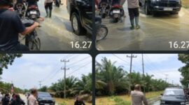 Personel Polsek Padang Tualang, Polres Langkat, Polda Sumatera Utara, bergerak cepat melakukan pengaturan lalu lintas di tengah kondisi banjir